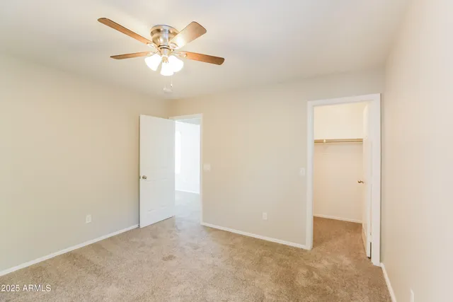 an empty room with fan and window