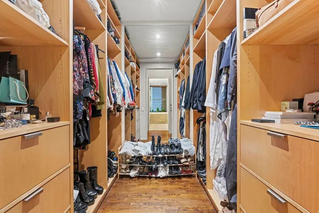 a room with painting on the wall and a potted plant