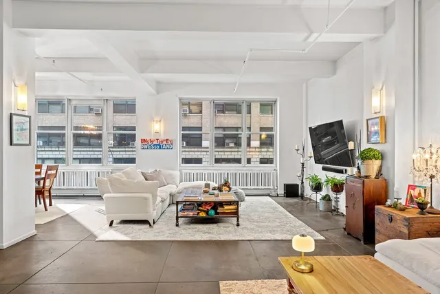 a room with furniture a chandelier and a window