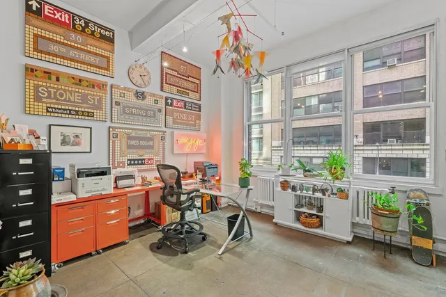 a bedroom with a bed chair and a large window