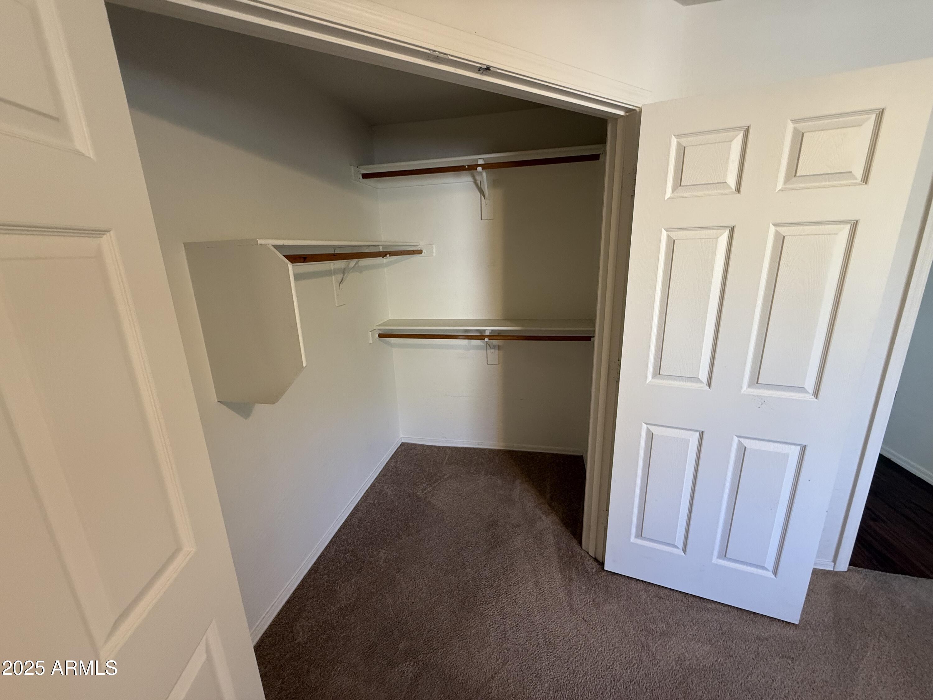 1287 North Alma School Road, Unit 260 Chandler, AZ 85224 - Photo 15 of 20 a view of a closet with wooden floor