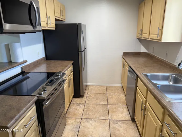 a kitchen with a stove microwave and sink