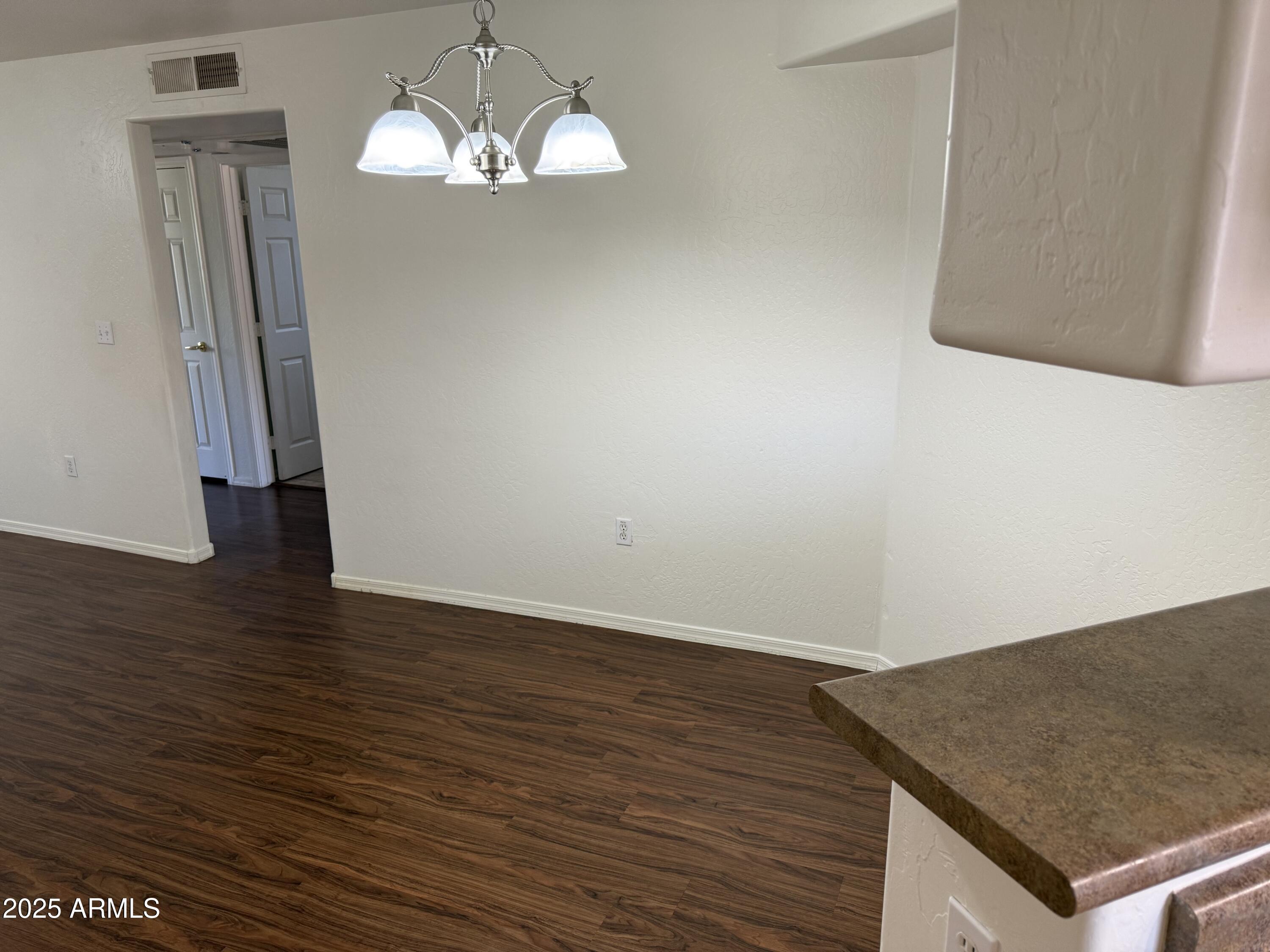 1287 North Alma School Road, Unit 260 Chandler, AZ 85224 - Photo 4 of 20 a view of a livingroom with wooden floor and a ceiling fan