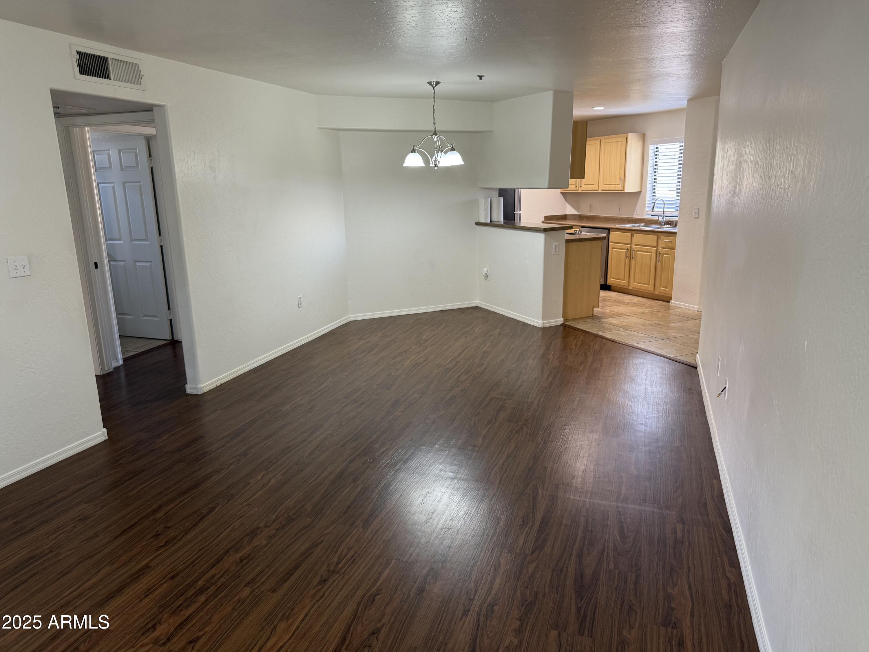 1287 North Alma School Road, Unit 260 Chandler, AZ 85224 - Photo 5 of 20 wooden floor in an empty room with a window