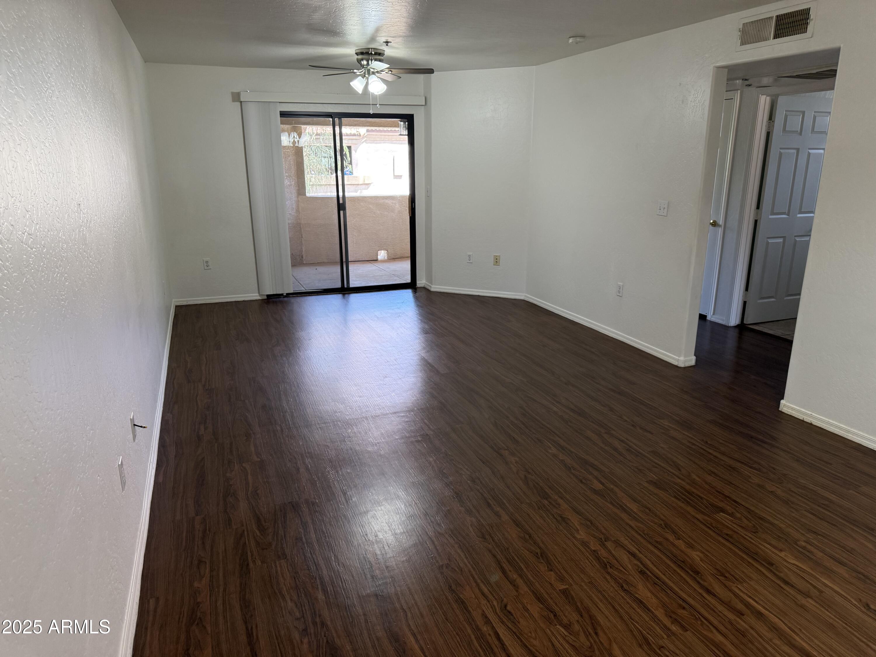 1287 North Alma School Road, Unit 260 Chandler, AZ 85224 - Photo 6 of 20 an empty room with wooden floor and windows
