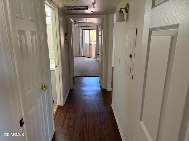 a view of a hallway with wooden floor