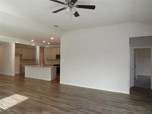 a view of kitchen with kitchen island stainless steel appliances sink and refrigerator