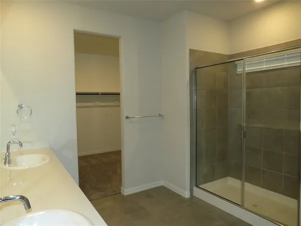 a bathroom with a shower and a sink