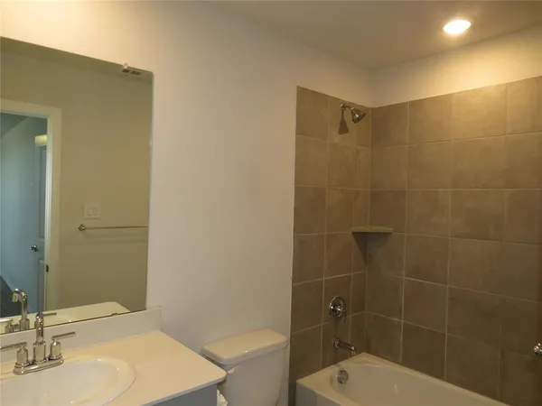 a bathroom with a sink shower and a toilet