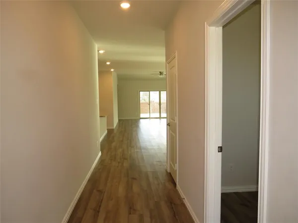 a view of hallway with wooden floor