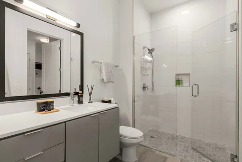 a bathroom with a sink toilet and shower