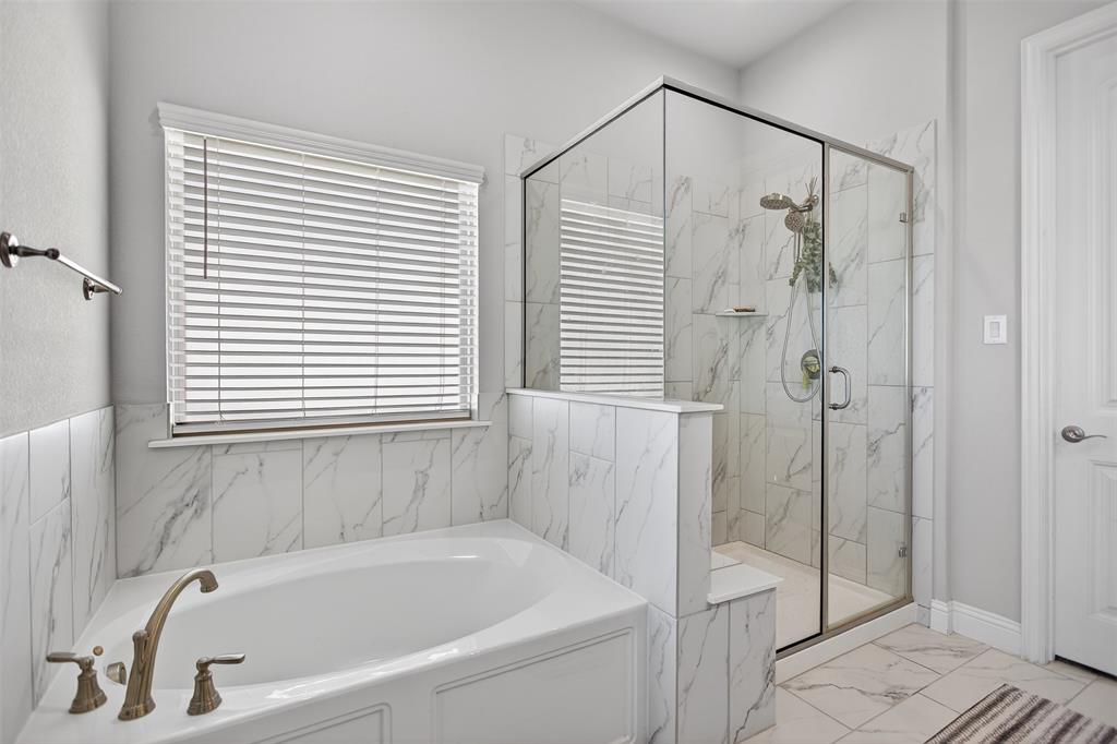 6829 Danridge Road Rowlett, TX 75089 - Photo 13 of 28 a white bath tub sitting next to a shower