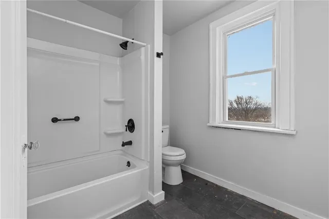 a bathroom with a bathtub a toilet and a shower