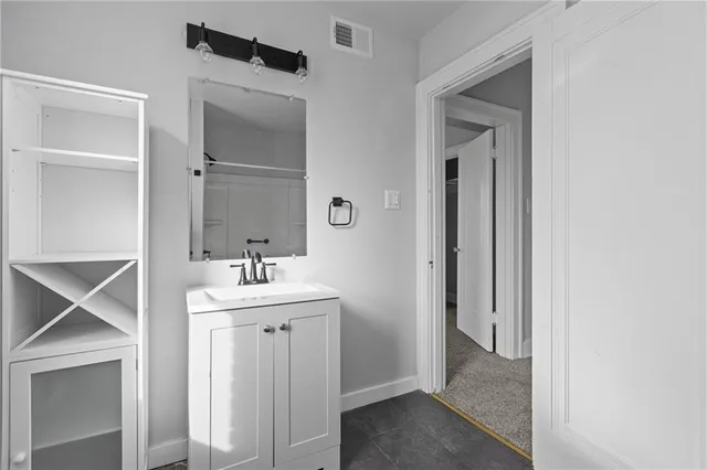 a bathroom with a sink and mirror