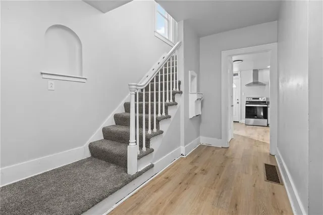 a view of entryway and hall with wooden floor