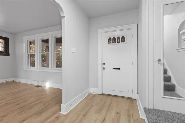 a view of an entryway with wooden floor