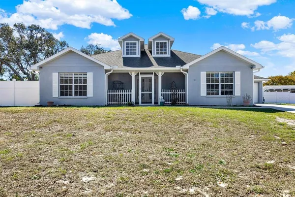 a front view of house with yard and garage