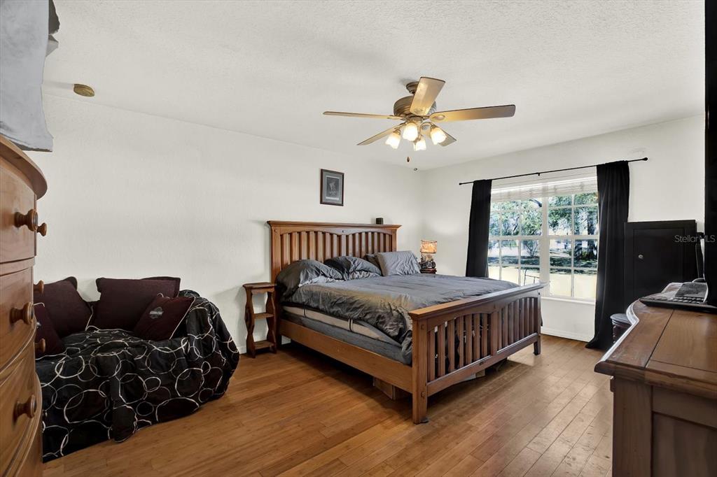 8240 Neda Street Spring Hill, FL 34606 - Photo 20 of 53 a bedroom with bed and wooden floor