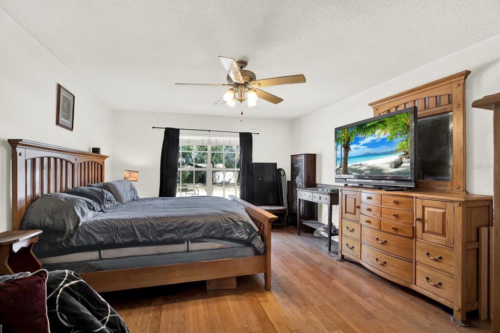 8240 Neda Street Spring Hill, FL 34606 - Photo 21 of 53 a bedroom with furniture and a flat screen tv