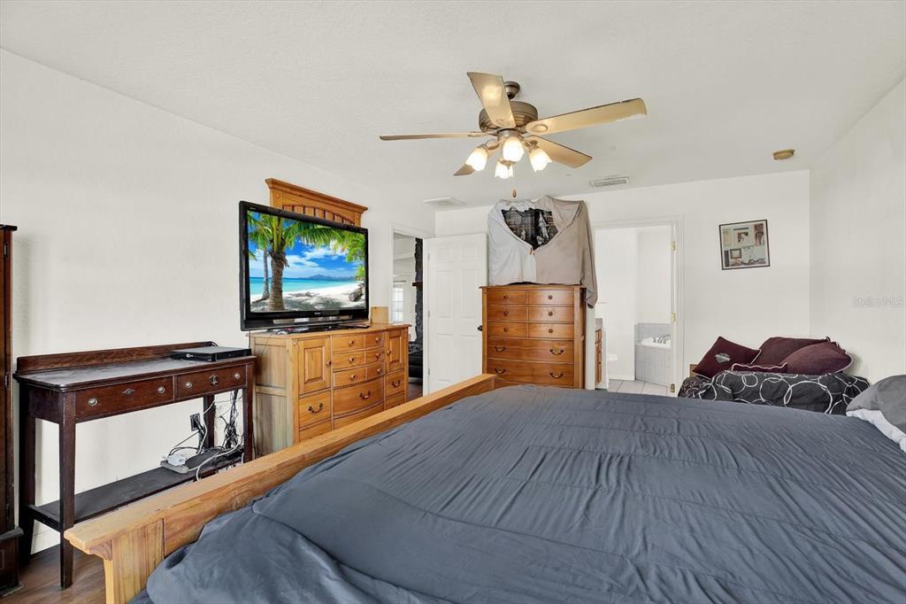 8240 Neda Street Spring Hill, FL 34606 - Photo 22 of 53 a bedroom with a bed and a flat screen tv