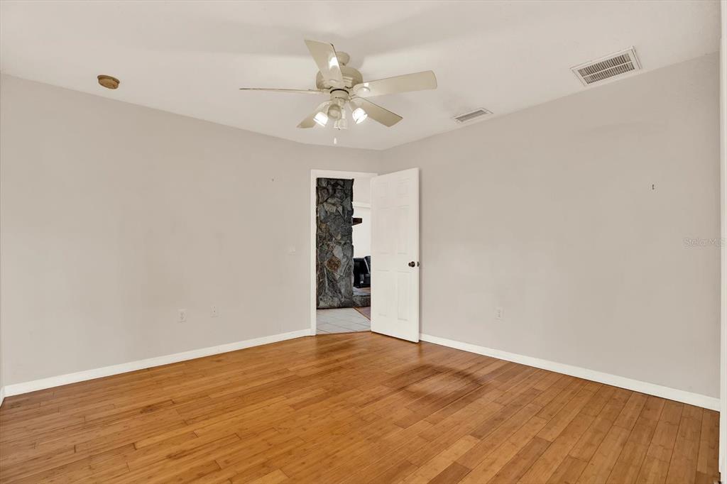 8240 Neda Street Spring Hill, FL 34606 - Photo 26 of 53 a view of an empty room with wooden floor