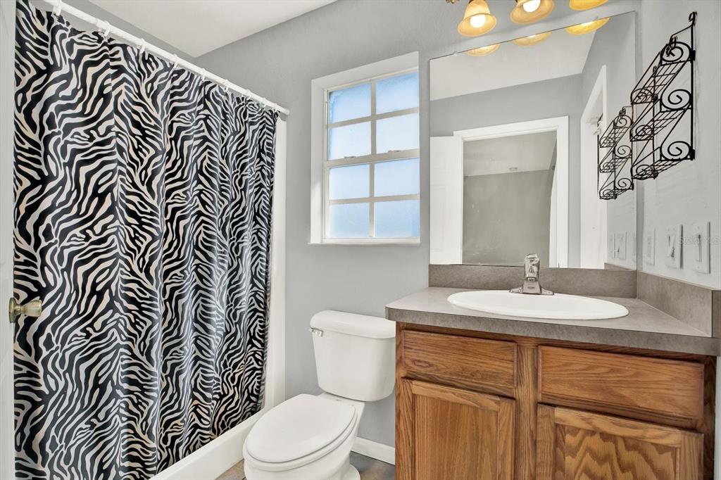 8240 Neda Street Spring Hill, FL 34606 - Photo 28 of 53 a bathroom with a granite countertop sink and a toilet