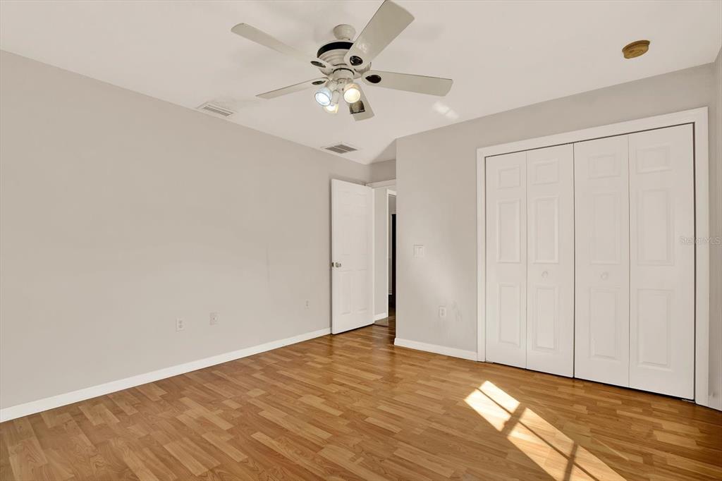 8240 Neda Street Spring Hill, FL 34606 - Photo 31 of 53 a view of an empty room with wooden floor