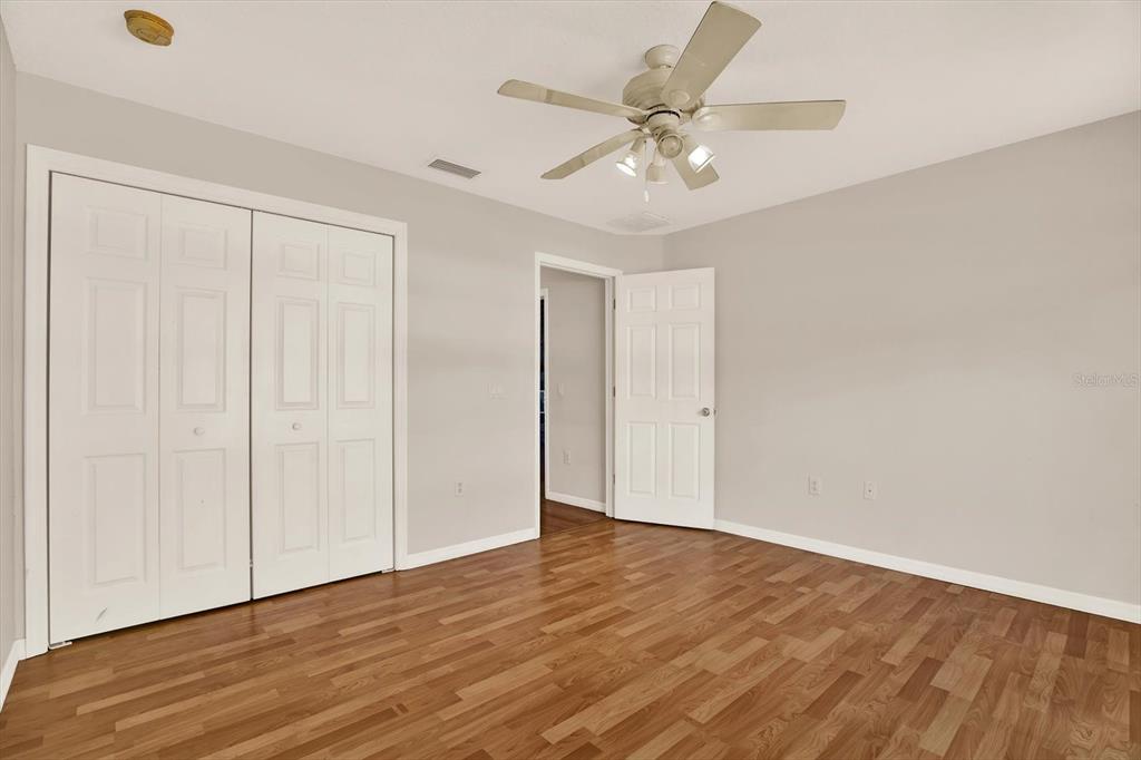 8240 Neda Street Spring Hill, FL 34606 - Photo 35 of 53 a view of an empty room with wooden floor