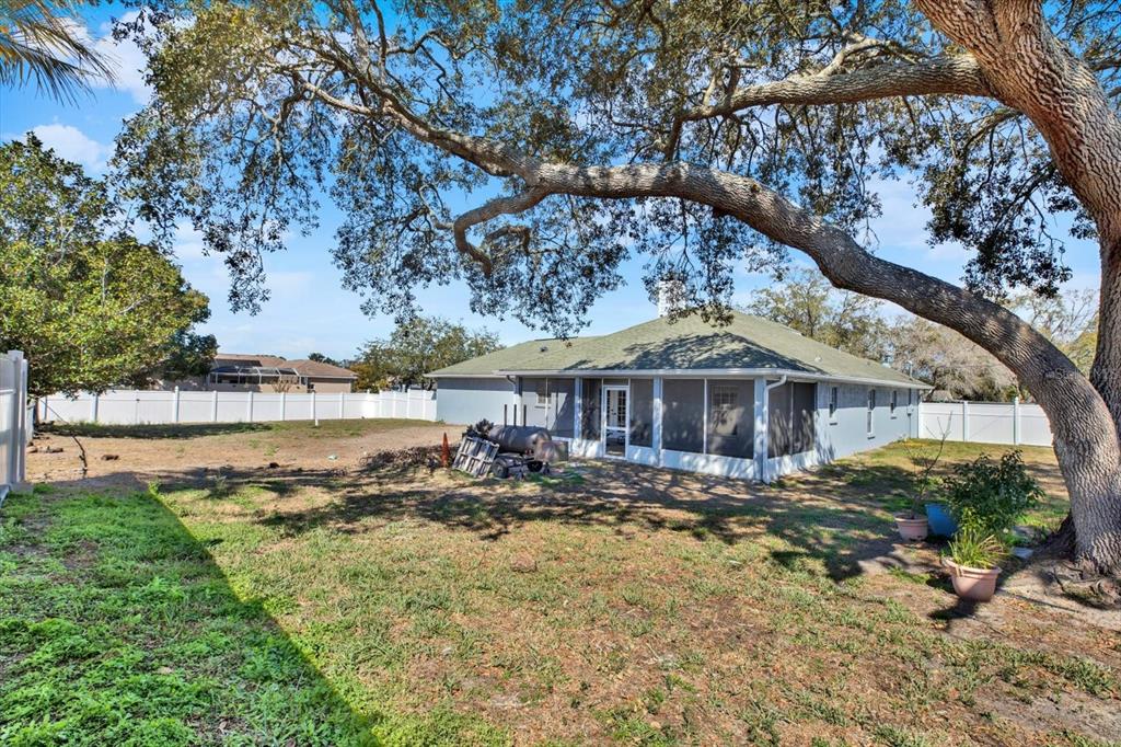 8240 Neda Street Spring Hill, FL 34606 - Photo 41 of 53 a front view of a house with a yard and lake view