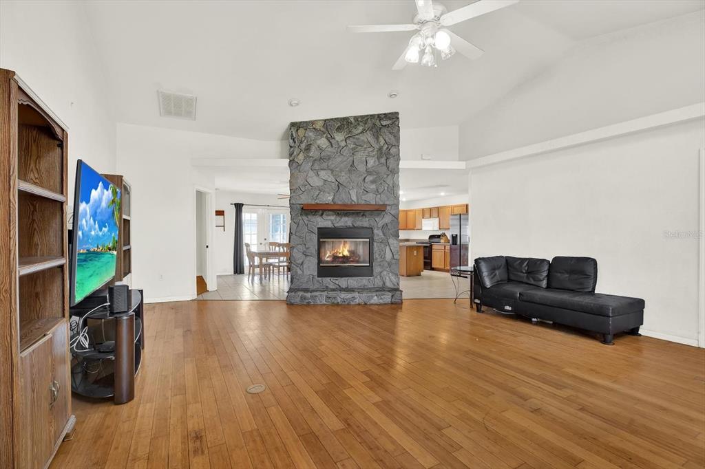 8240 Neda Street Spring Hill, FL 34606 - Photo 5 of 53 a living room with furniture and a flat screen tv