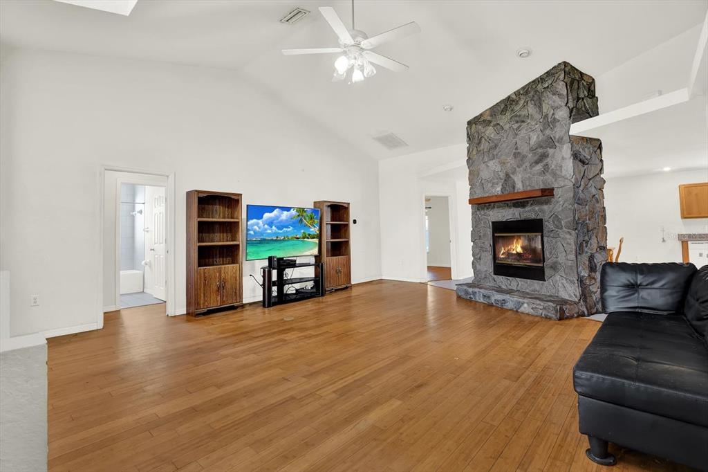 8240 Neda Street Spring Hill, FL 34606 - Photo 7 of 53 a living room with furniture and a fireplace