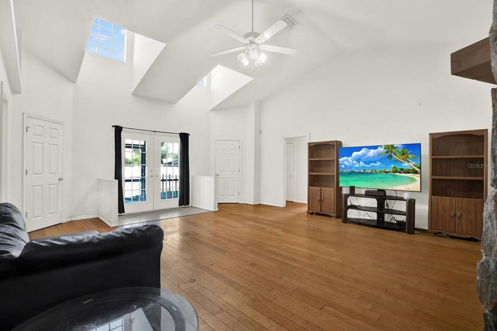 8240 Neda Street Spring Hill, FL 34606 - Photo 8 of 53 a living room with furniture and a flat screen tv
