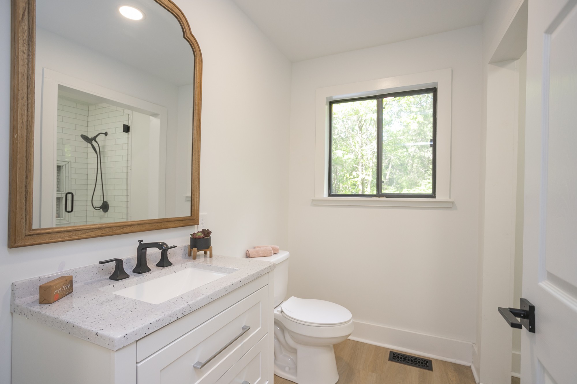 5860 Cane Ridge Road Antioch, TN 37013 - Photo 13 of 46 a bathroom with a sink vanity granite toilet and a mirror