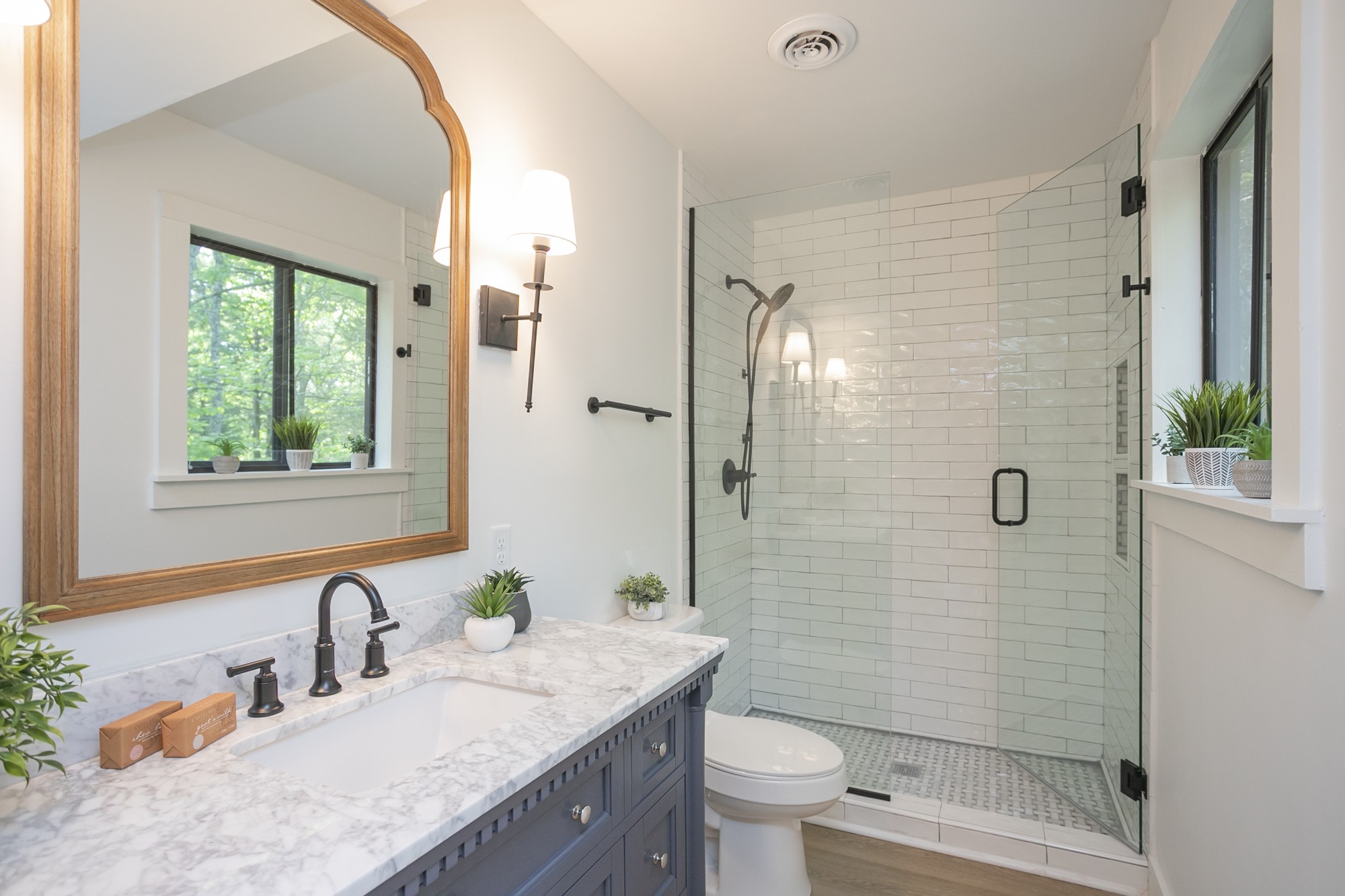 5860 Cane Ridge Road Antioch, TN 37013 - Photo 24 of 46 a bathroom with a granite countertop sink a toilet a mirror and shower