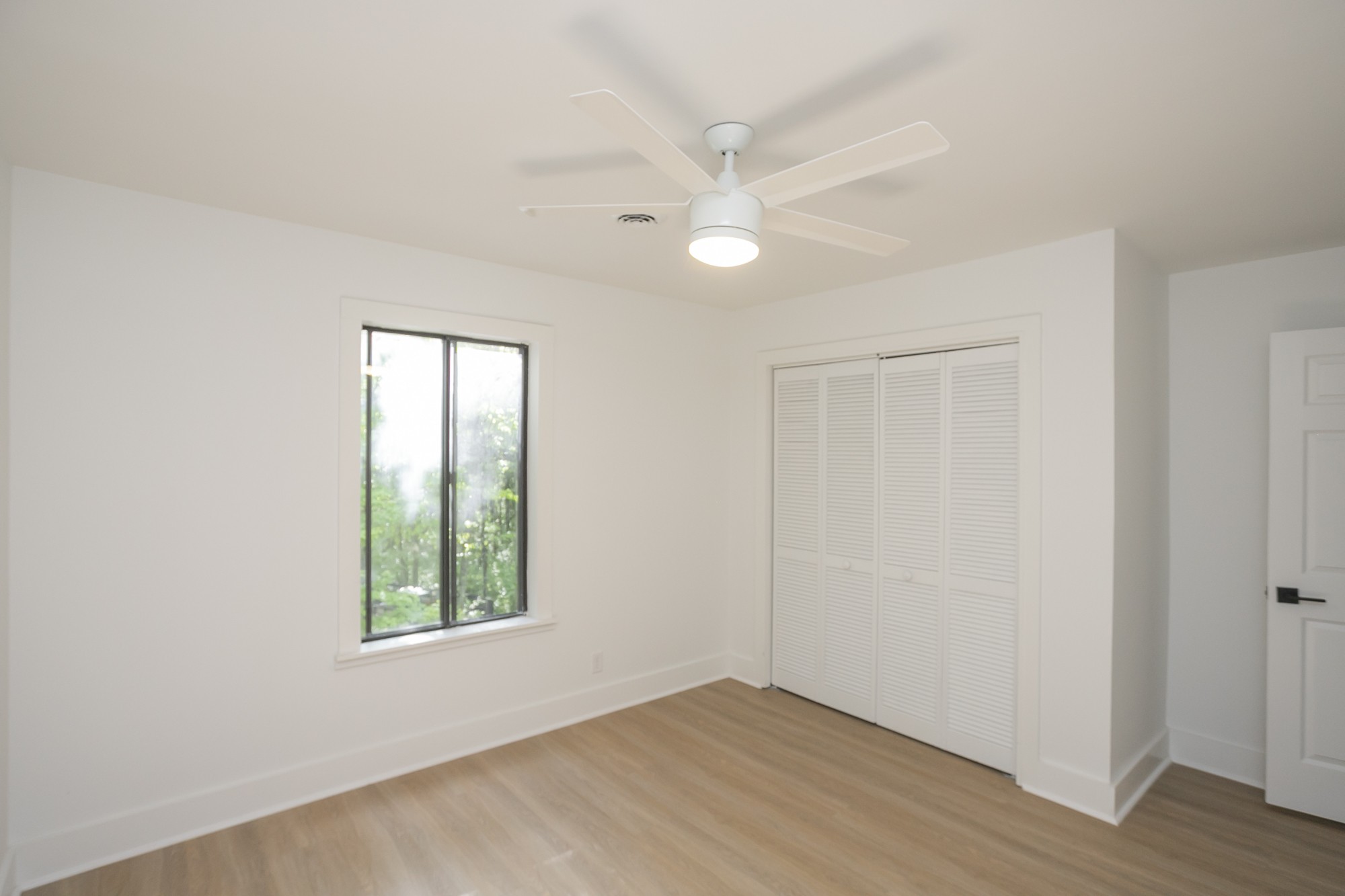 5860 Cane Ridge Road Antioch, TN 37013 - Photo 27 of 46 an empty room with wooden floor closet and windows