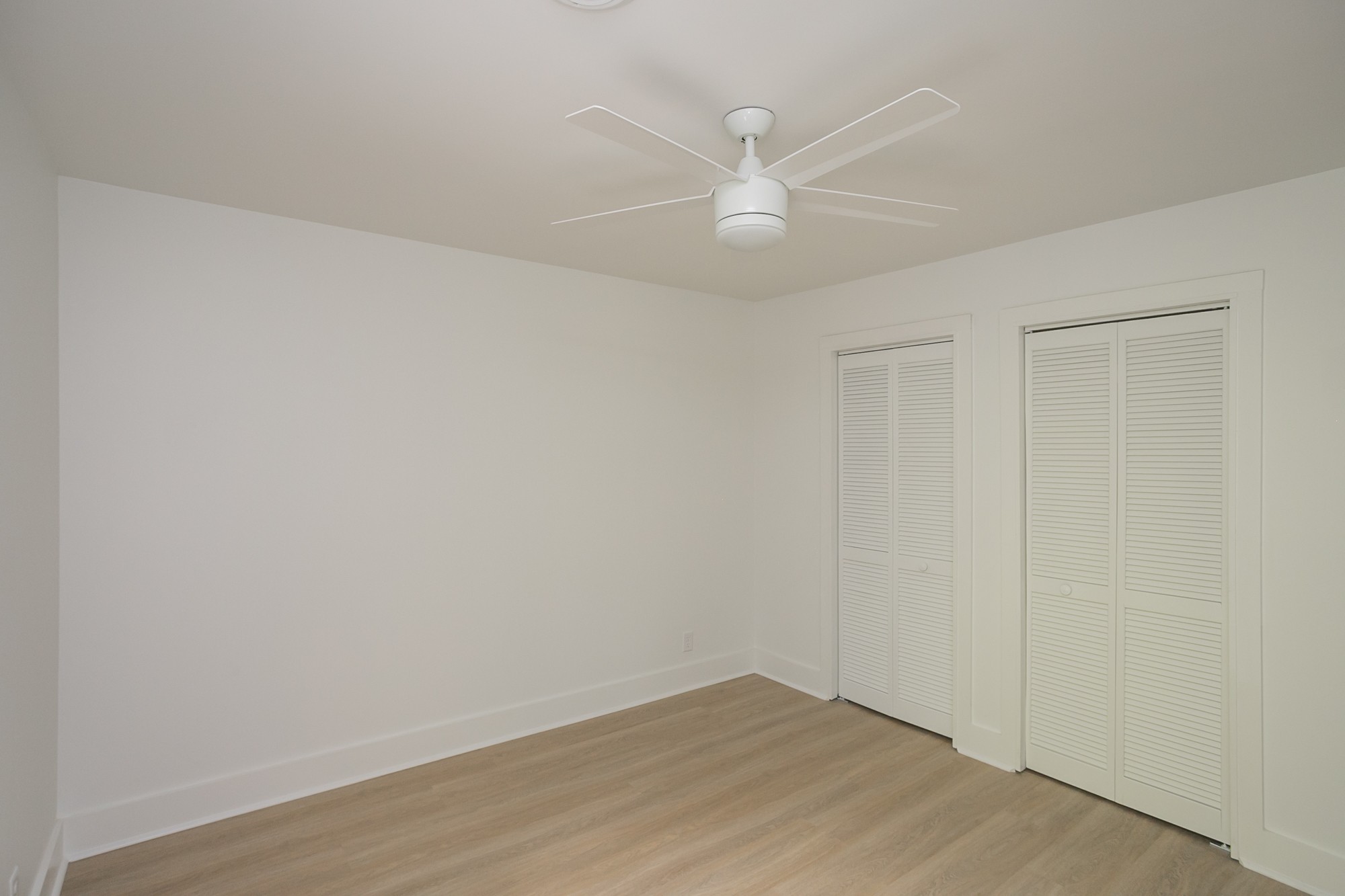 5860 Cane Ridge Road Antioch, TN 37013 - Photo 28 of 46 an empty room with a ceiling fan and wooden floor
