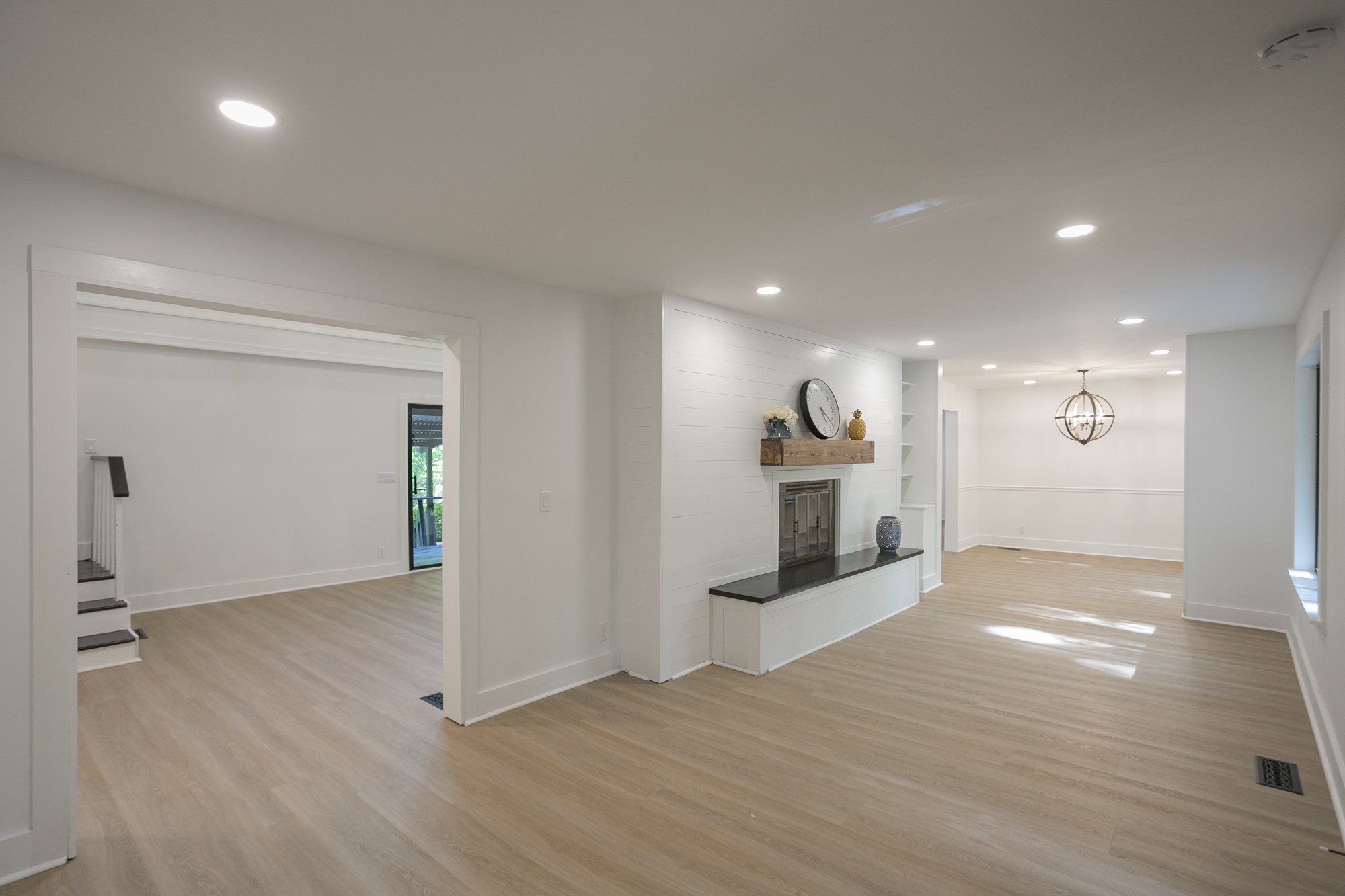 5860 Cane Ridge Road Antioch, TN 37013 - Photo 8 of 46 an empty room with wooden floor fireplace and windows