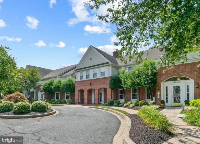 a front view of a house with a garden and plants