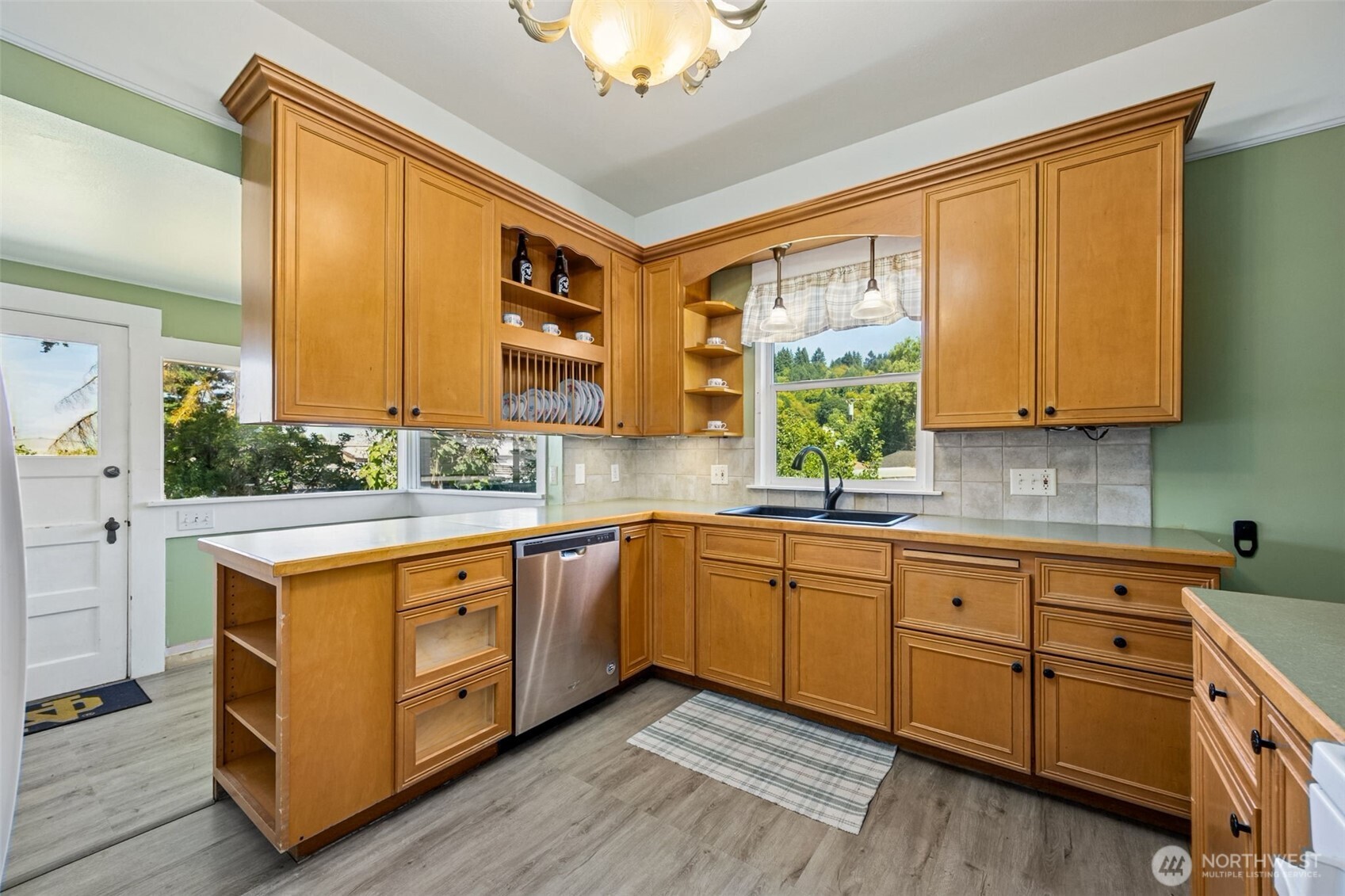 668 Northwest Folsom Street Chehalis, WA 98532 - Photo 11 of 34 a kitchen with stainless steel appliances granite countertop wooden cabinets a sink and a large window