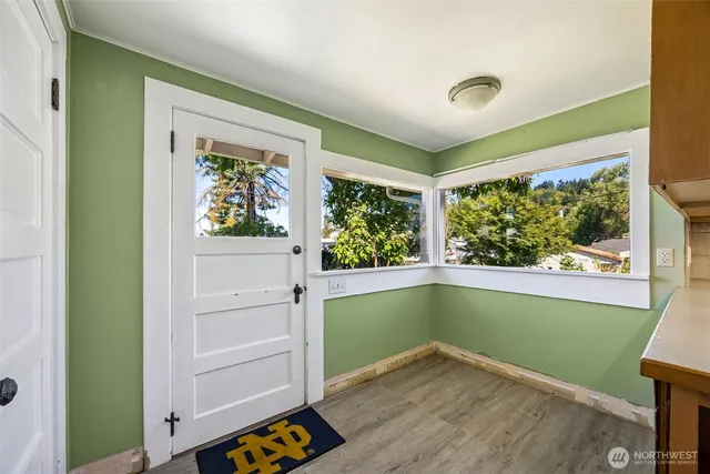 a room with window and painting on the wall