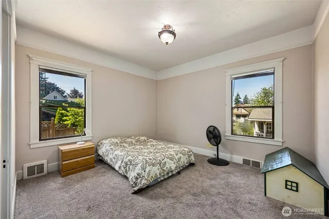 a bedroom with bed and a window