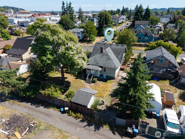 an aerial view of a house with a yard basket ball court and outdoor seating