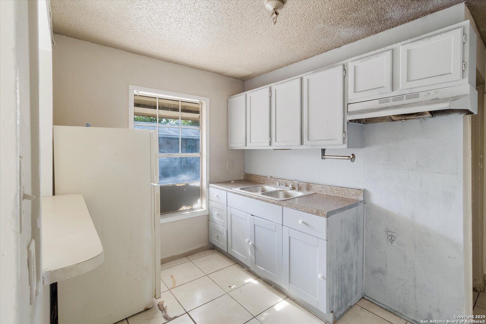 3620 Rivas Street San Antonio, TX 78228 - Photo 7 of 15 a kitchen with a cabinets and white appliances