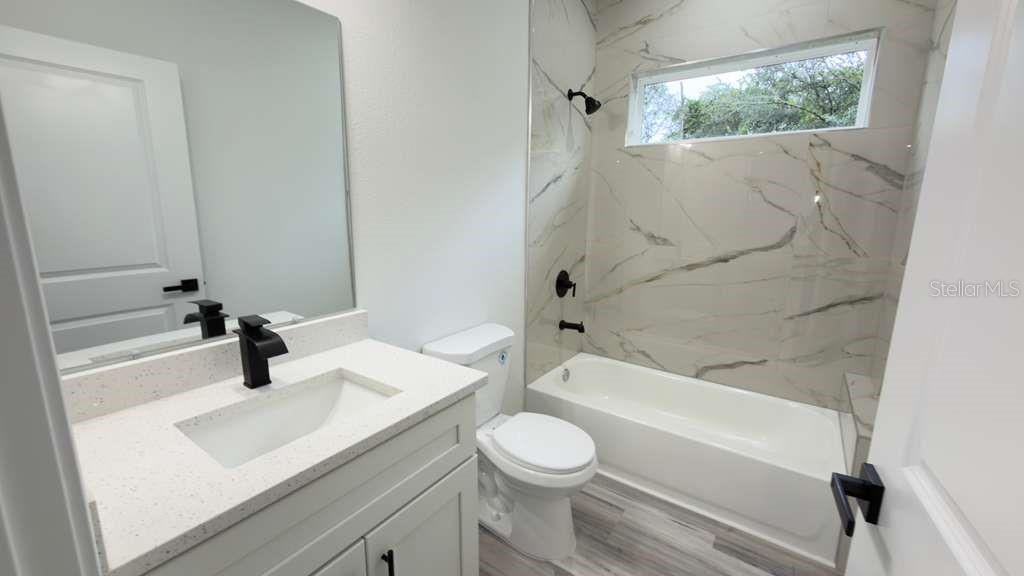 14905 Southwest 24th Circle Ocala, FL 34472 - Photo 9 of 24 a bathroom with a sink a toilet and shower