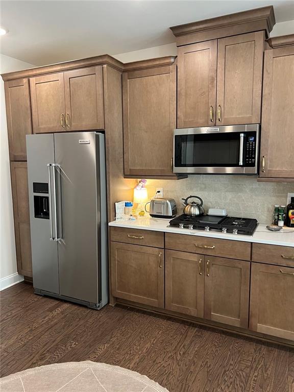 704 Calypso Way Cumming, GA 30040 - Photo 16 of 33 a kitchen with stainless steel appliances a refrigerator a stove a microwave and sink