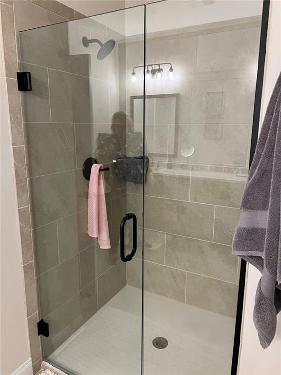 704 Calypso Way Cumming, GA 30040 - Photo 23 of 33 a bathroom with a shower