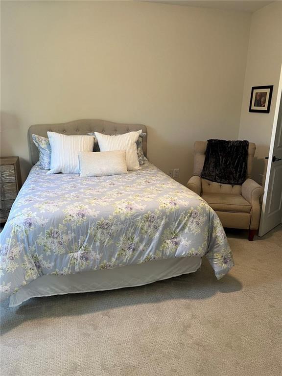 704 Calypso Way Cumming, GA 30040 - Photo 24 of 33 a large bed sitting in a bedroom next to a couch