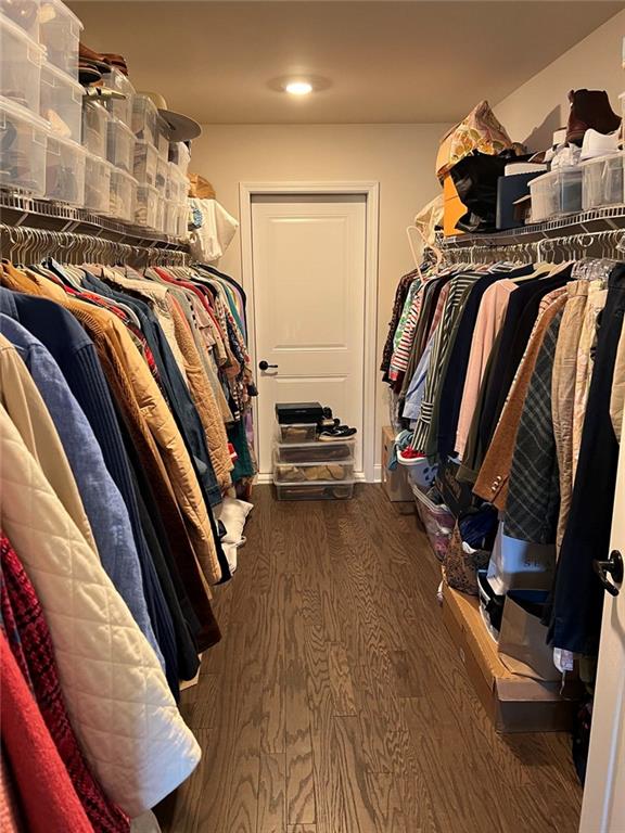704 Calypso Way Cumming, GA 30040 - Photo 25 of 33 a view of walk in closet with clothes and shoes