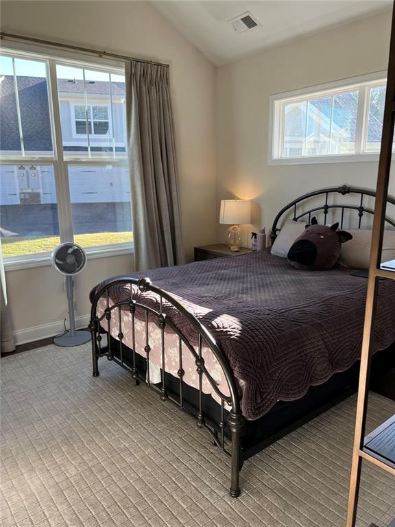 704 Calypso Way Cumming, GA 30040 - Photo 27 of 33 a bedroom with a bed next to a window