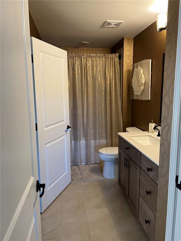 704 Calypso Way Cumming, GA 30040 - Photo 28 of 33 a bathroom with a double vanity sink toilet mirror and tub